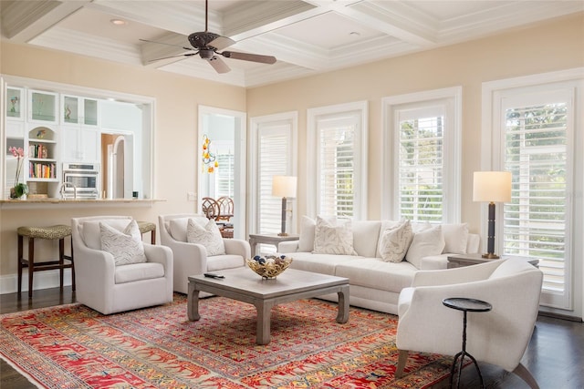 living area featuring crown molding, beam ceiling, coffered ceiling, and wood finished floors