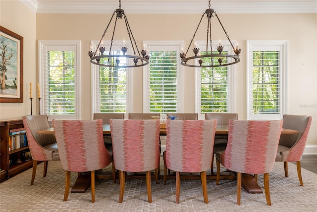 dining room featuring ornamental molding, plenty of natural light, and a notable chandelier