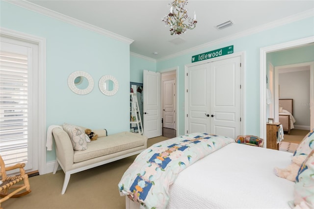 bedroom featuring carpet floors, crown molding, a notable chandelier, a closet, and visible vents