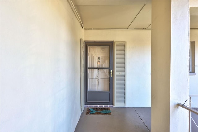 view of exterior entry featuring stucco siding