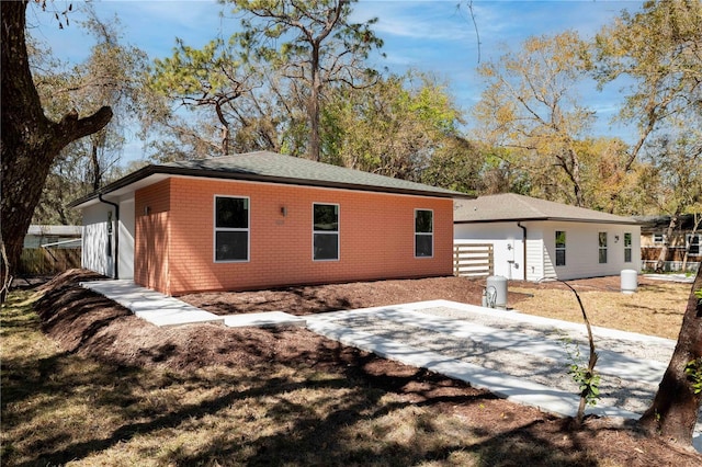 rear view of house with a patio area and brick siding