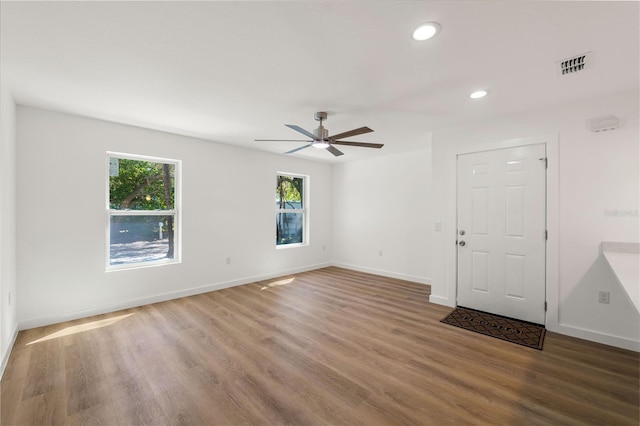 empty room featuring recessed lighting, wood finished floors, visible vents, and baseboards