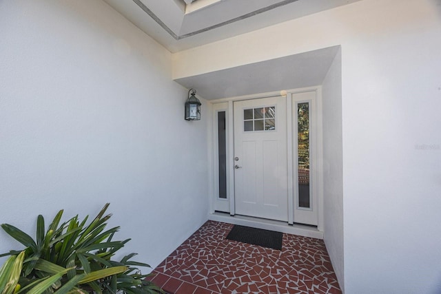 entrance to property with stucco siding