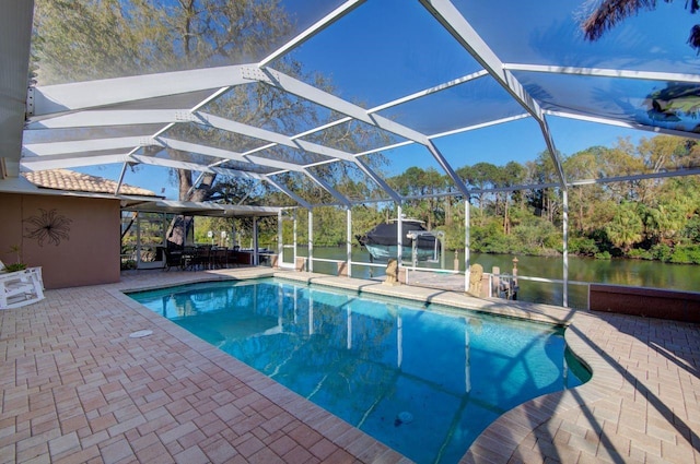 pool featuring a patio area, a lanai, and a water view