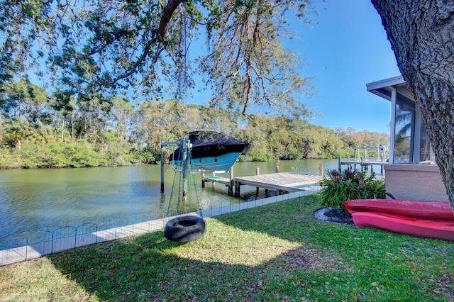 dock area with a water view and a lawn