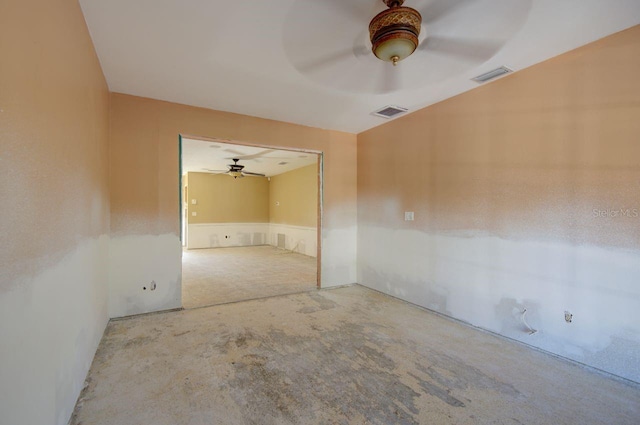 unfurnished room featuring visible vents, unfinished concrete flooring, and a ceiling fan