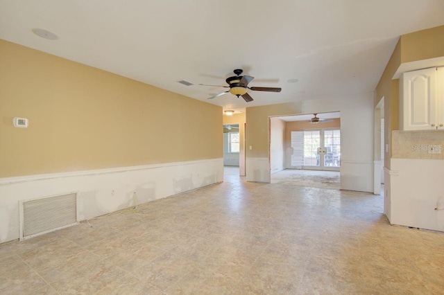 empty room featuring visible vents and ceiling fan