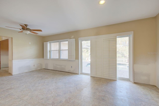 empty room featuring ceiling fan and a healthy amount of sunlight