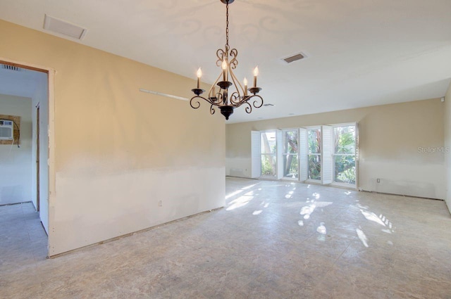 empty room featuring visible vents and a notable chandelier