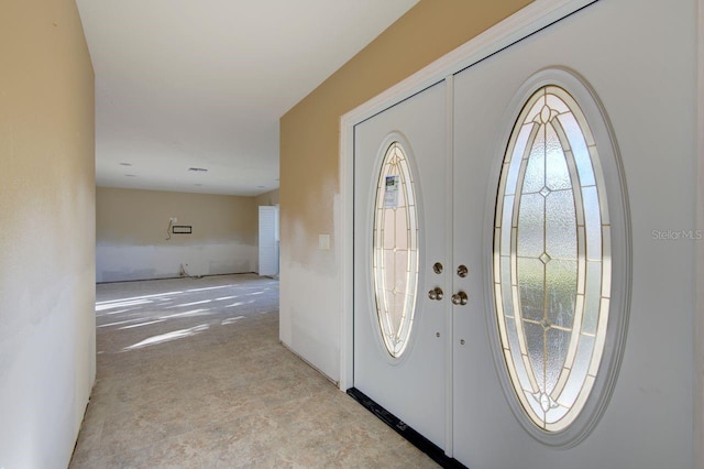 foyer featuring french doors and a healthy amount of sunlight