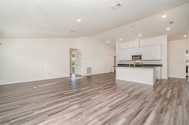 unfurnished living room featuring recessed lighting, visible vents, and light wood finished floors