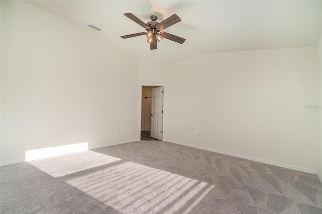 unfurnished room with lofted ceiling, light colored carpet, visible vents, a ceiling fan, and baseboards