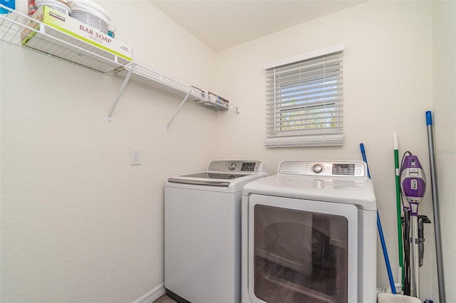 laundry room featuring laundry area, baseboards, and washer and dryer