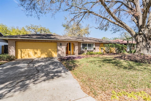 single story home featuring aphalt driveway, brick siding, an attached garage, and a front lawn