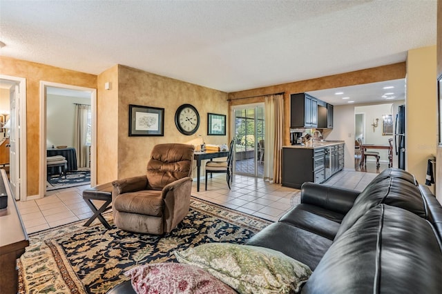 living room featuring a textured ceiling and light tile patterned flooring