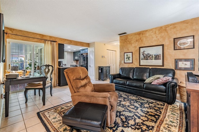 living area with visible vents and light tile patterned floors