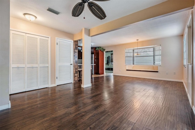 unfurnished living room featuring a ceiling fan, baseboards, visible vents, and dark wood-type flooring