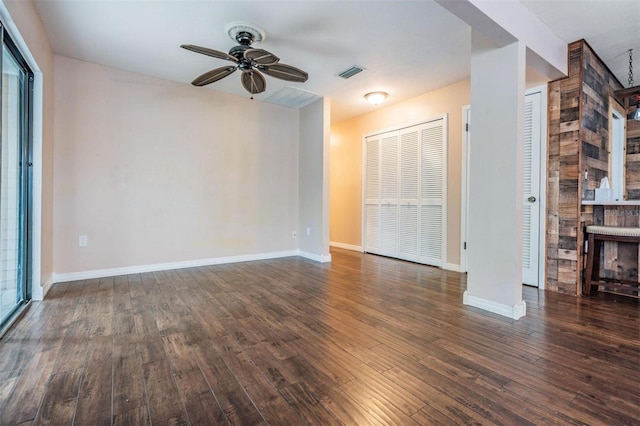 unfurnished living room featuring baseboards, hardwood / wood-style flooring, visible vents, and a ceiling fan