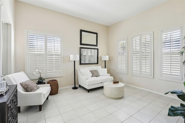 sitting room featuring light tile patterned floors and baseboards