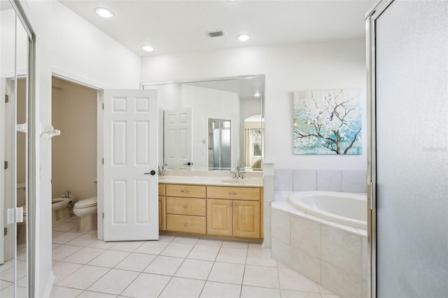 bathroom featuring tile patterned flooring, vanity, visible vents, a bath, and a bidet