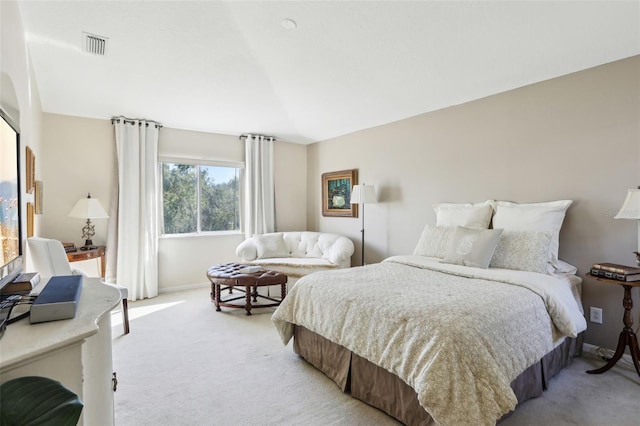 bedroom with lofted ceiling, light colored carpet, visible vents, and baseboards