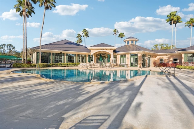 community pool with a patio area