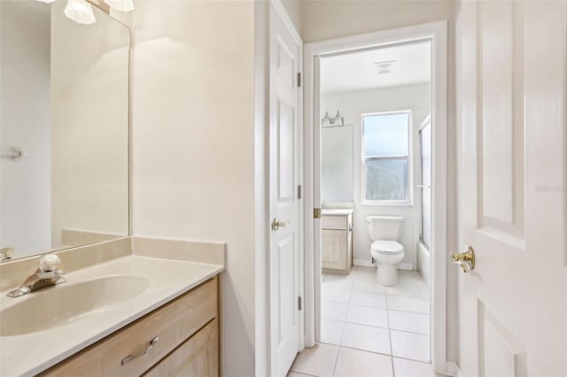 full bathroom featuring visible vents, toilet, enclosed tub / shower combo, vanity, and tile patterned floors