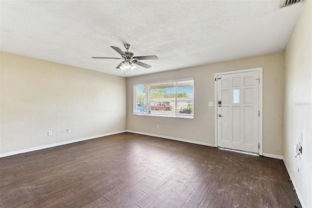 foyer entrance featuring visible vents, baseboards, dark wood-style floors, ceiling fan, and a textured ceiling