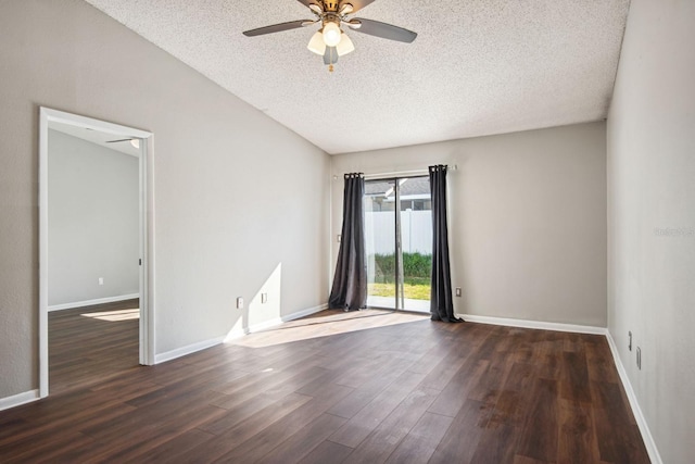 empty room featuring a textured ceiling, baseboards, and wood finished floors