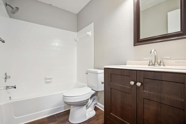 bathroom featuring washtub / shower combination, vanity, wood finished floors, and toilet