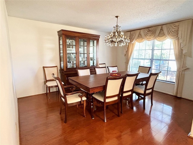 dining area featuring a textured ceiling and an inviting chandelier