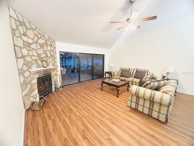 15013 Redcliff Dr, Tampa, FL 33625 - living area featuring lofted ceiling, wood finished floors, a ceiling fan, and a fireplace