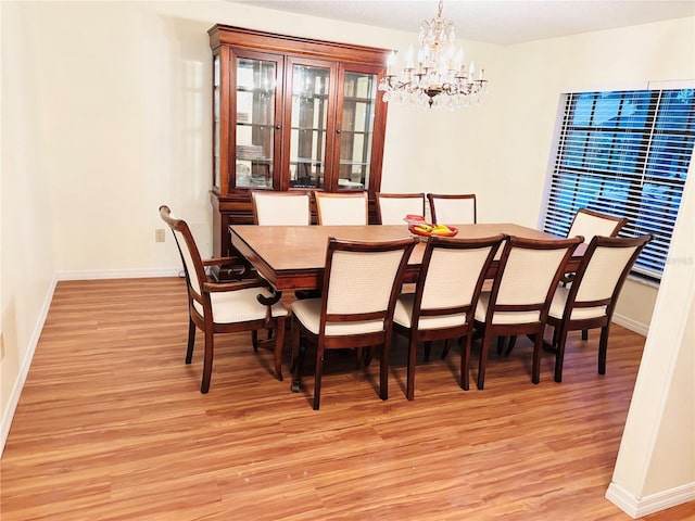 15013 Redcliff Dr, Tampa, FL 33625 - dining area with light wood-style floors, a chandelier, and baseboards