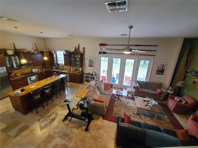 living room featuring french doors and visible vents