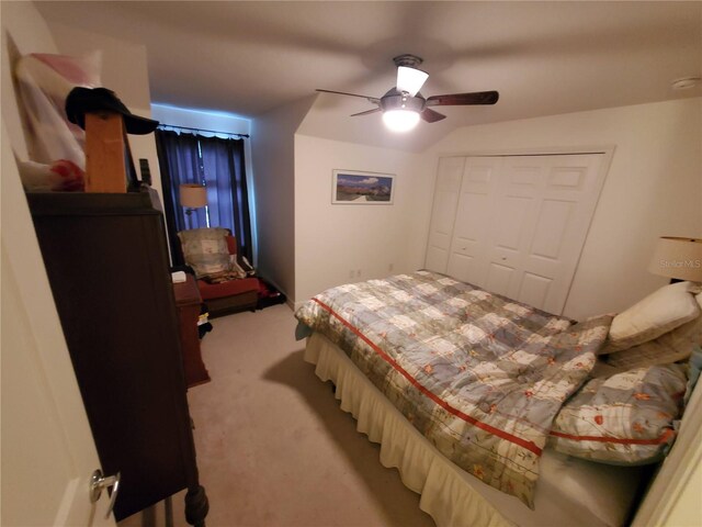 bedroom featuring light carpet, a closet, and a ceiling fan