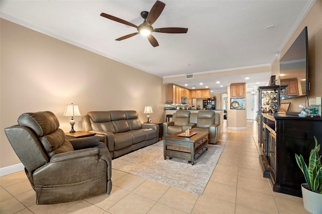 living area with visible vents, crown molding, baseboards, and light tile patterned floors