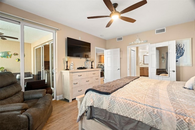 bedroom featuring light wood-style floors, visible vents, a ceiling fan, and ensuite bathroom