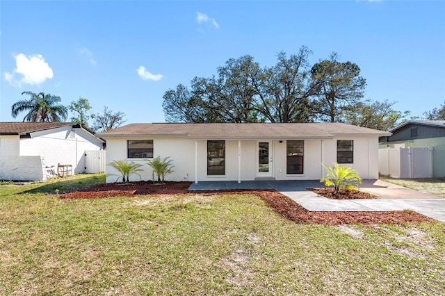 ranch-style house with driveway, a front lawn, fence, and a gate