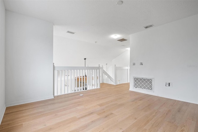 unfurnished room featuring light wood-type flooring and visible vents