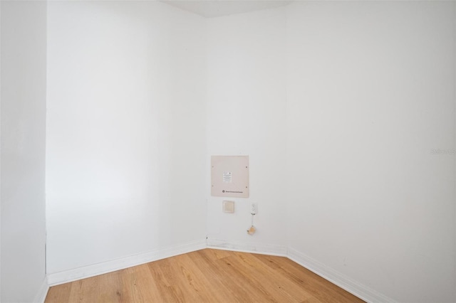 unfurnished room featuring baseboards and light wood finished floors