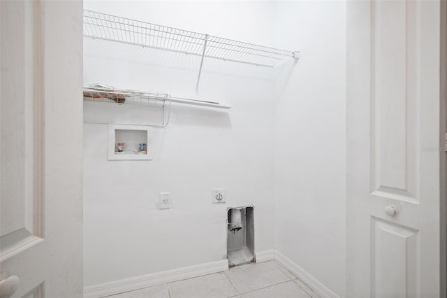 laundry room featuring light tile patterned floors, laundry area, baseboards, hookup for a washing machine, and hookup for an electric dryer