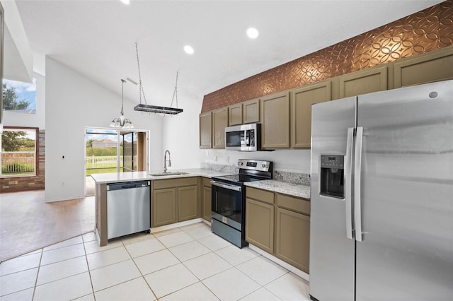 kitchen with light tile patterned floors, a peninsula, a sink, appliances with stainless steel finishes, and wallpapered walls