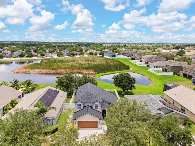 bird's eye view featuring a water view and a residential view