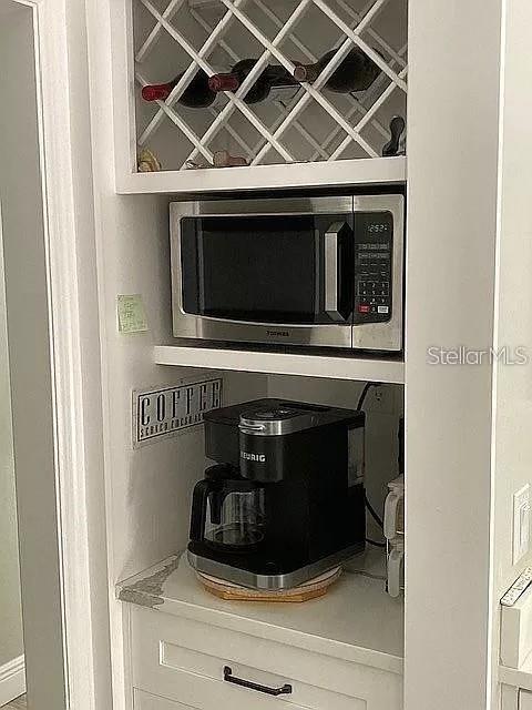 room details with light countertops and stainless steel microwave