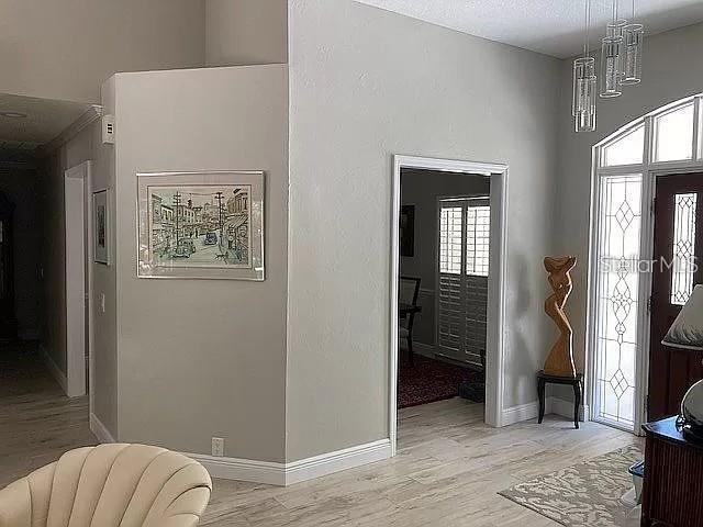 entryway with light wood-style floors and baseboards