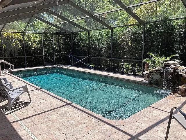 pool with a lanai and a patio