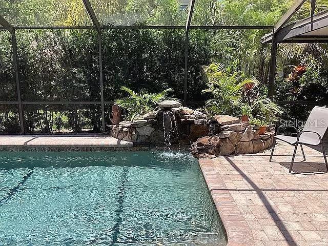 outdoor pool featuring a patio and a lanai