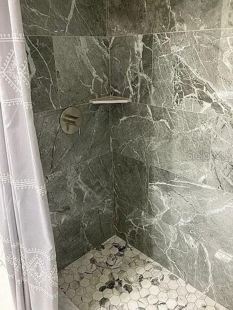 bathroom featuring tiled shower