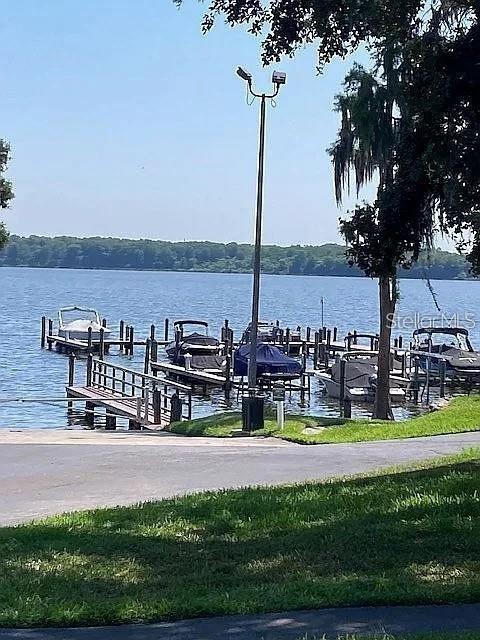 dock area with a water view and boat lift