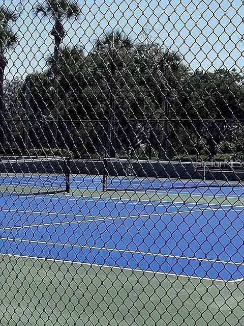 view of sport court with fence